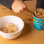 Scooping coffee flavored ice cream that is decaffeinated.