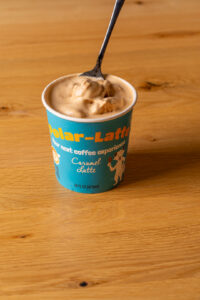 Caramel Latte coffee ice cream pint with a spoon.